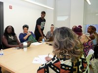 People at a table looking at something in the distance.