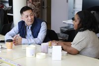 Two people discuss over their products.