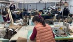 Worker at sewing machine in a garment factory