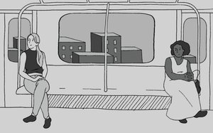 Two women sitting at opposite sides of a subway train car. 