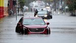 2 stalled cars are submerged in floodwaters on 9th Street near 2nd Avenue in Brooklyn.