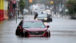 2 stalled cars are submerged in floodwaters on 9th Street near 2nd Avenue in Brooklyn.